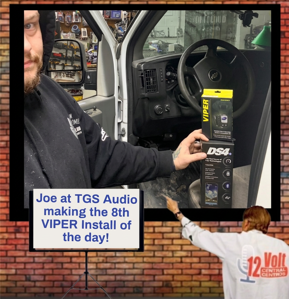 A man holding a Viper DS4 car remote start system inside a vehicle, with an interior view showing the steering wheel and dashboard. Text overlay announces it's the 8th Viper install of the day at TGS Audio.